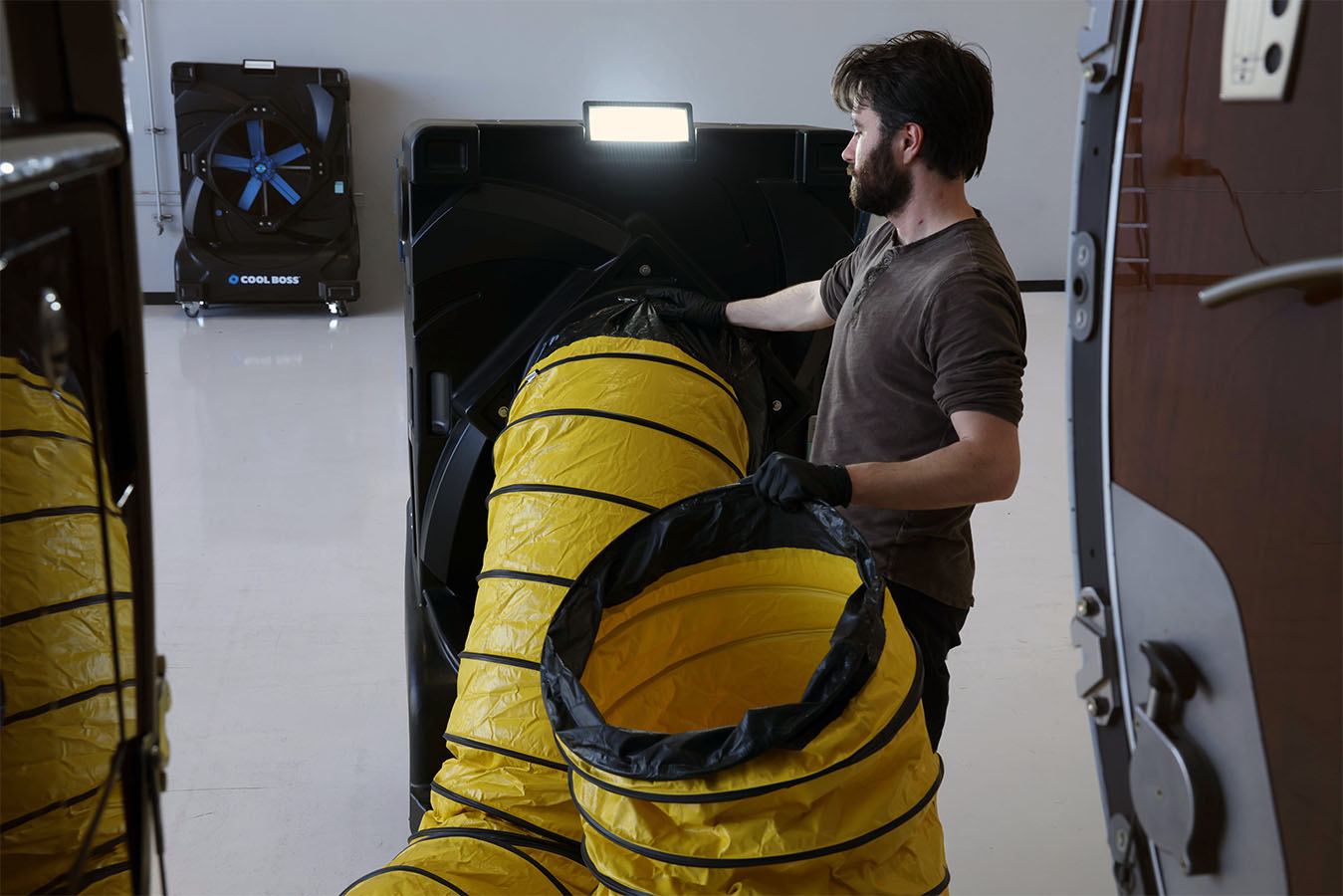 Cool Boss evaporative air cooler being used in an automotive garage